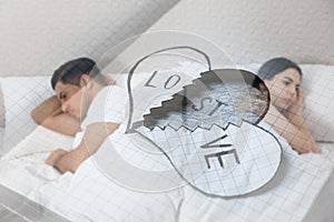 Double exposure of unhappy couple with relationship problems and broken paper heart