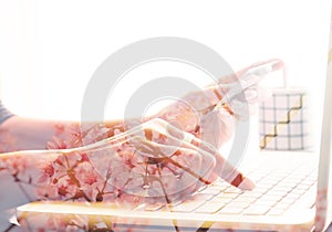 Double exposure of woman hand using laptop and credit card