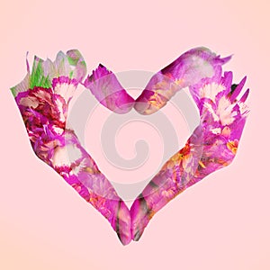 Double exposure of woman hands forming a heart and flowers