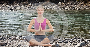Double exposure of woman meditating at lake shore