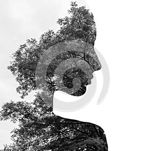 Double exposure of young beautiful girl among the leaves and trees. Black and white silhouette Isolated on white.