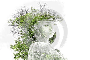 Double exposure of young beautiful girl among the leaves and trees. Portrait of attractive lady combined with photograph of tree