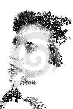 Double exposure of young beautiful girl among the leaves and trees. Portrait of attractive lady combined with photograph of tree.