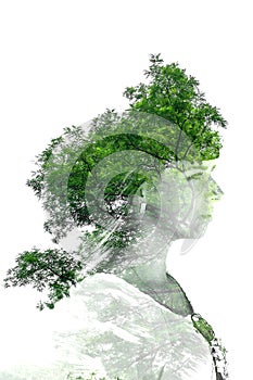 Double exposure of young beautiful girl among the leaves and trees. Portrait of a woman, mysterious look, creative, art, conceptua