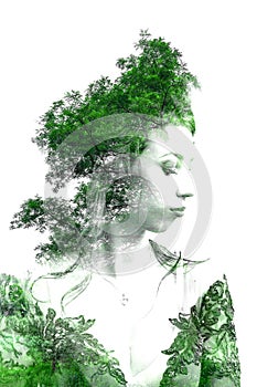 Double exposure of young beautiful girl among the leaves and trees. Portrait of a woman, mysterious look, creative, art, conceptua