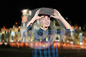 Double exposure of young man using VR headset glasses for virtual reality goggles