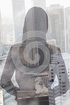 Double exposure of young woman over cityscape