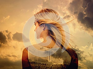 Double exposure of young woman and the sky