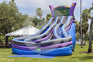 Double the fun with the colorful Twin Falls dual bounce house slides