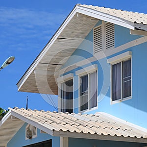 Double gable house soars into blue sky