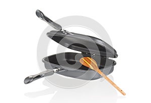 Double grill pan with non-stick multi usage with wooden spoon isolated on white background