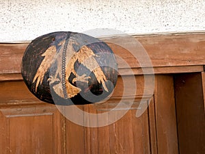 Double headed hawk symbol of Albania on top of the wooden door