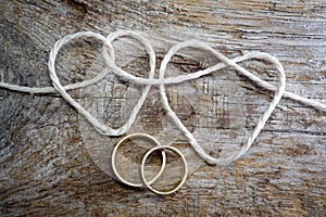 Double heart shaped rope and a double gold ring