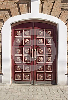 massive wooden doors of a brick house photo