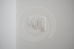 Double light switch on gray wall