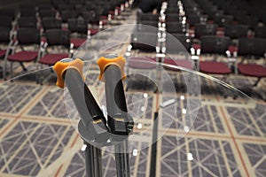 Double microphone on a glass round side table at conference hall