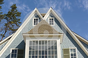 Double-peaked roof of blue family home