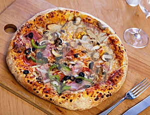 Double pizza served on wooden board