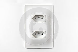 Double plug socket on the wall isolated on white