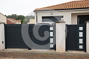 Double portal large metal gate high grey fence on suburb street house door