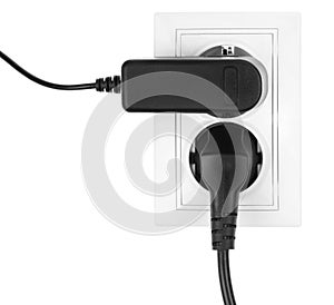 Double power European electric plug isolated on a white. Black electric cord plugged into a white electricity socket on white