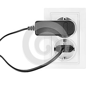 Double power European electric plug isolated on a white. Black electric cord plugged into a white electricity socket on white