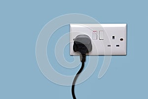 Double power socket and single plug switched on photo