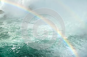 Double rainbow across river and waterfall