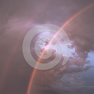 Double rainbow on the background of the cloudy sky