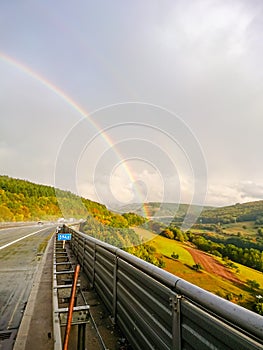 A double rainbow after a heavy rain over the highway in Bavaria, Germany