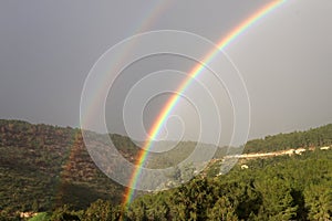 Double rainbow in the mountains after rain