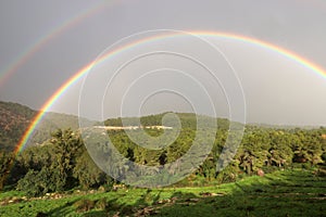 Double rainbow in the mountains after rain