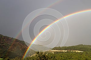 Double rainbow in the mountains after rain