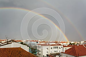 Double rainbow over buildings