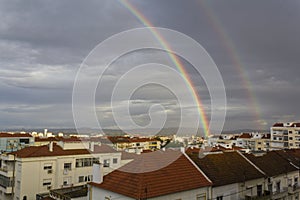 Double rainbow over buildings