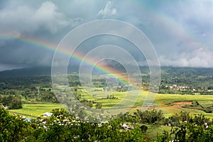 Double Rainbow Over Countryside with a Storm background. Ruteng, Manggarai Regency, Flores, East Nusa Tenggara, Indonesia photo