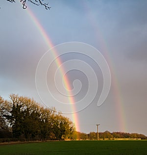 Double rainbow over field