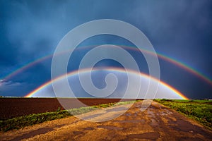 Double rainbow over field