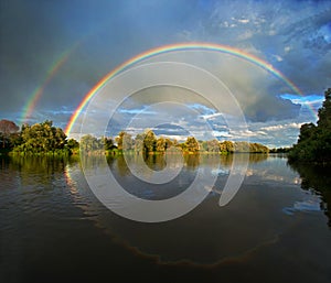 Double rainbow over river