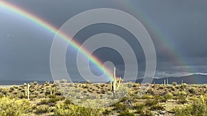 Double rainbow with rain falling in the desert