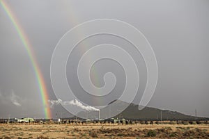 Double rainbow rising over an industrial area