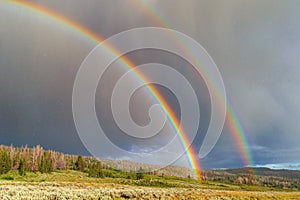 Double rainbow with sun and rain