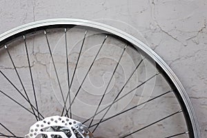 A double rim of a bicycle wheel without a tire, against a background of a textured eraser. Bicycle wheel repair, hub, bicycle iron