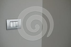 Double silver light switch on the wall