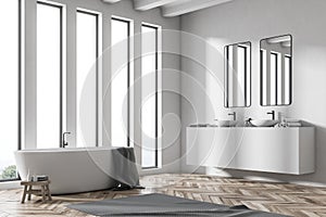 Double sink white bathroom with bathtub side view