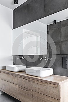 Double sinks in white, concrete and wooden bathroom interior