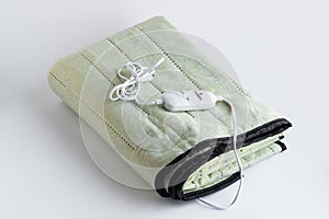 Double size,folded electric blanket on the white surface