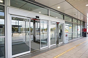 Double sliding glass doors with automatic motion sensor