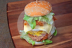 Double stacked crispy fried chicken burger recipe as sunny egg,cheese,mayonnaise, tomato sauce and lettuce