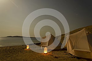 Double tent beach camp at night